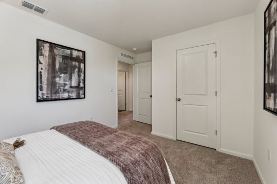 A bedroom with a bed and a door. A bedroom with a bed and a door.