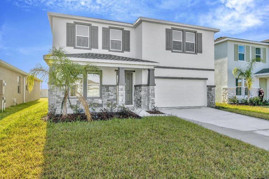 Front exterior of a new home in Mangrove Manor, Apollo Beach, FL, highlighting curb appeal (Image 22).