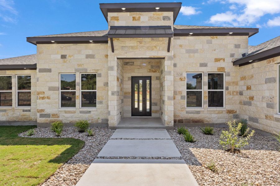 A striking stone facade with a prominent entryway creates an inviting curb appeal. A striking stone facade with a prominent entryway creates an inviting curb appeal.