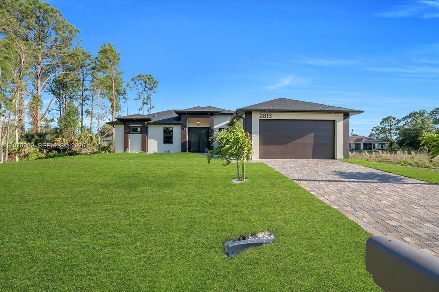 Front exterior of a new home in , Lehigh Acres, FL, highlighting curb appeal (Image 25).