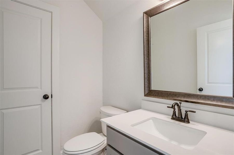 Bathroom featuring vanity and toilet