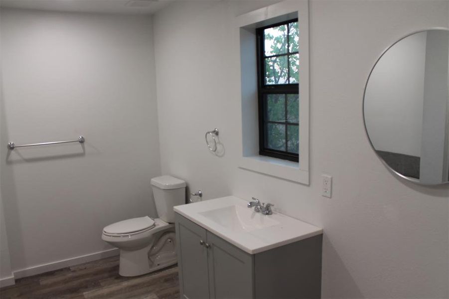 Half bath with vanity and dark wood finished floors