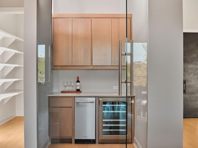 A stylish bar area with wine fridge and an ice maker make this kitchen perfect for serving and entertaining.