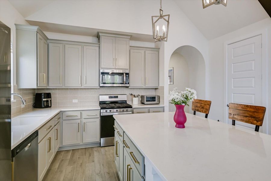 Quartz countertops, ample counter and cabinet space