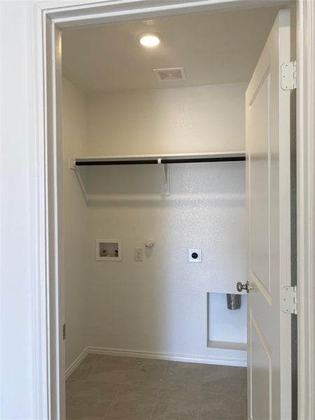 Clothes washing area featuring laundry area, visible vents, gas dryer hookup, washer hookup, and electric dryer hookup