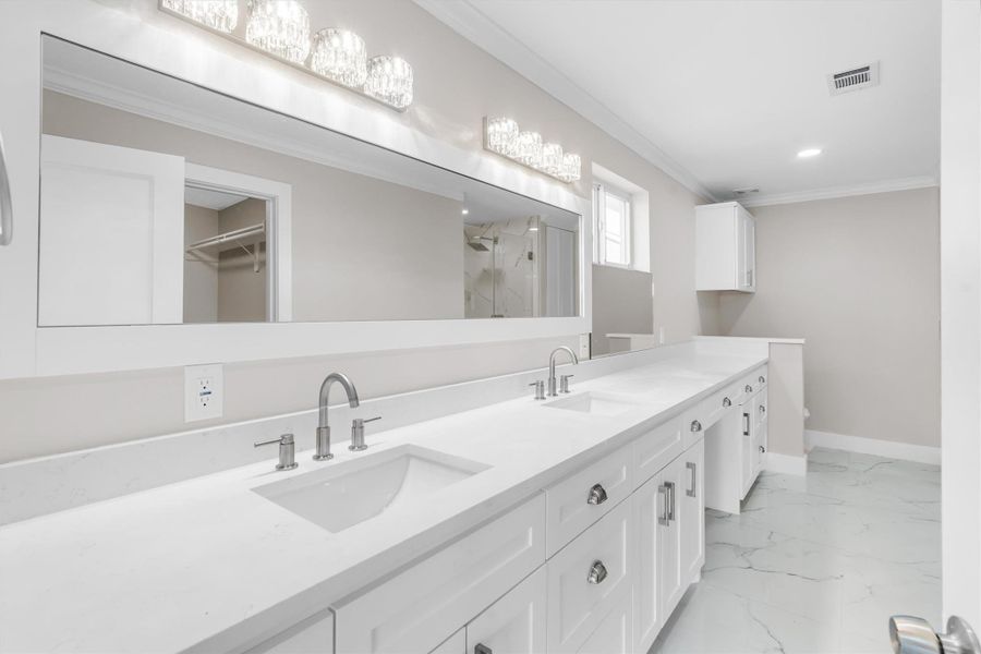 Primary en suite featuring a Texas sized framed mirror, double sinks, additional counter/storage space Primary en suite featuring a Texas sized framed mirror, double sinks, additional counter/storage space