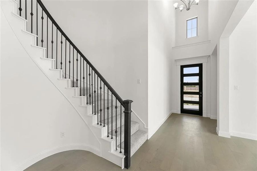 Entryway with a chandelier, french doors, a towering ceiling, and a wealth of natural light