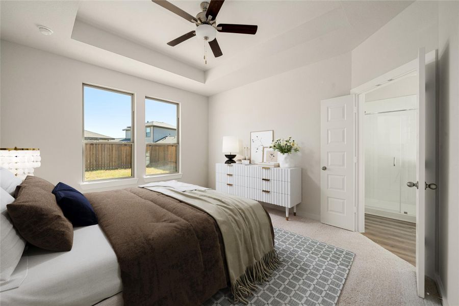 This serene primary suite offers a spacious layout with large windows that fill the room with natural light. The tray ceiling adds a touch of elegance, while the en-suite bath provides a private retreat for relaxation. This serene primary suite offers a spacious layout with large windows that fill the room with natural light. The tray ceiling adds a touch of elegance, while the en-suite bath provides a private retreat for relaxation.