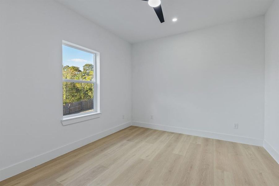 Unfurnished room with light hardwood / wood-style flooring and ceiling fan