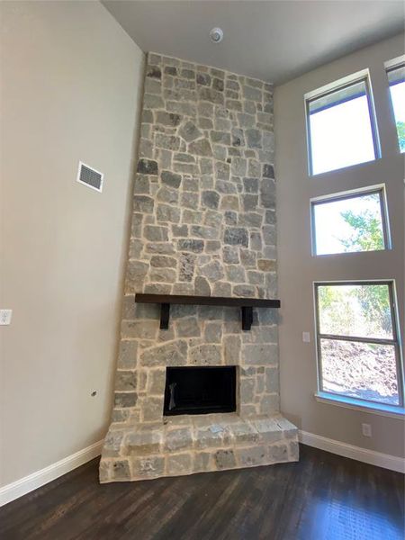 Massive gas stone fireplace to the ceiling with stained cedar mantle & raised hearth