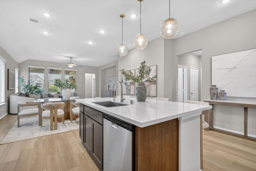 This modern, open-concept kitchen and dining area. It flows into a bright living space with ample natural light from multiple windows, creating a welcoming and spacious environment. This modern, open-concept kitchen and dining area. It flows into a bright living space with ample natural light from multiple windows, creating a welcoming and spacious environment.