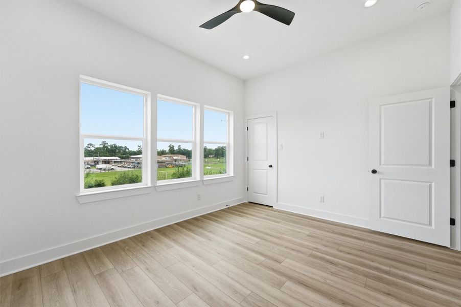 A different view of this expansive primary suite with a modern ceiling fan, walk-in closet and en-suite bath gives you everything a primary retreat should be. A different view of this expansive primary suite with a modern ceiling fan, walk-in closet and en-suite bath gives you everything a primary retreat should be.