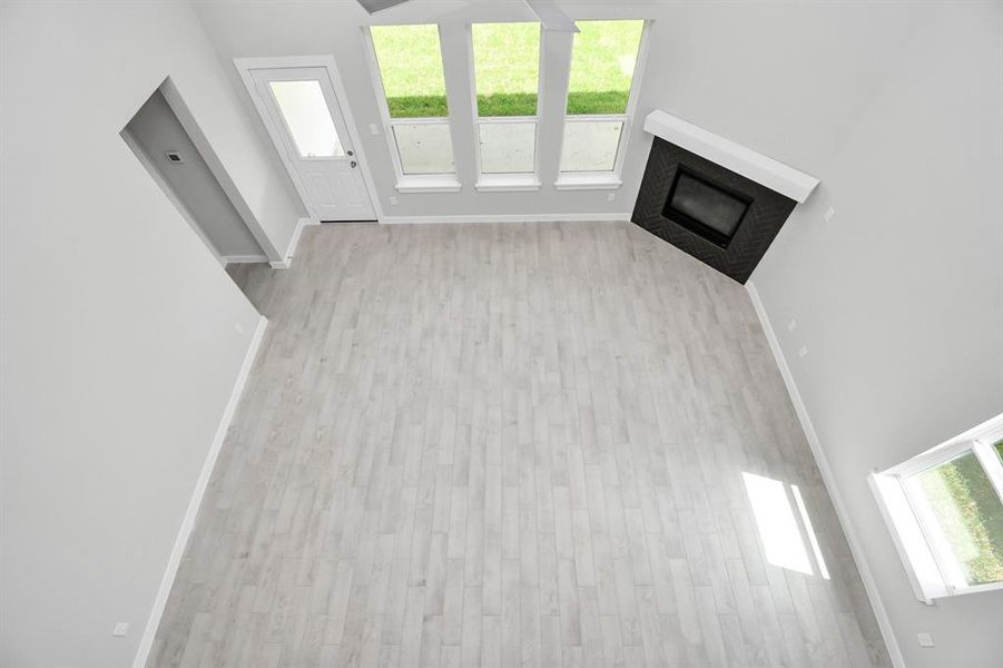 View of family room, from landing above.  Sample photo of completed home with similar plan. As built color and selections may vary.