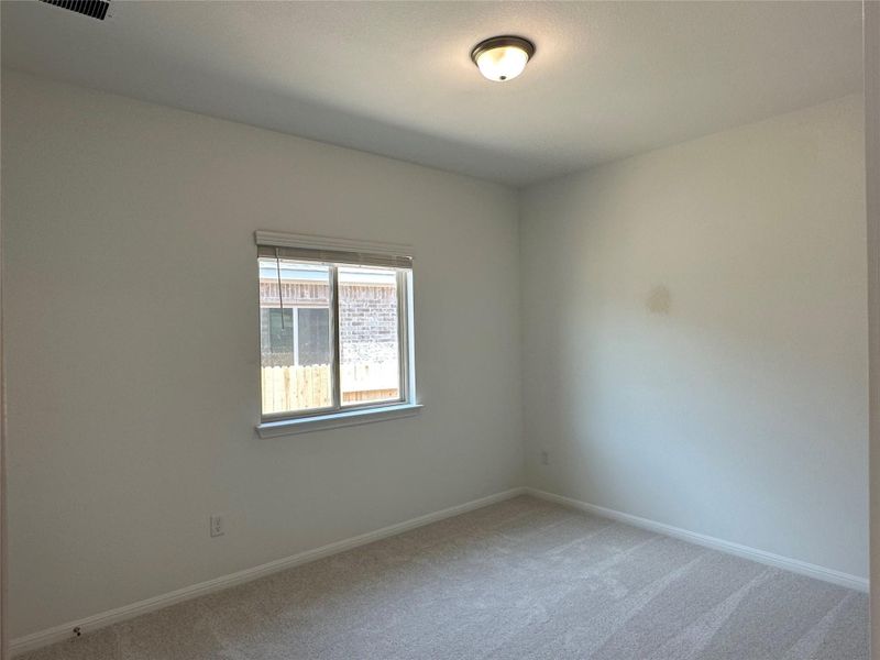 Unfurnished room featuring light colored carpet and baseboards