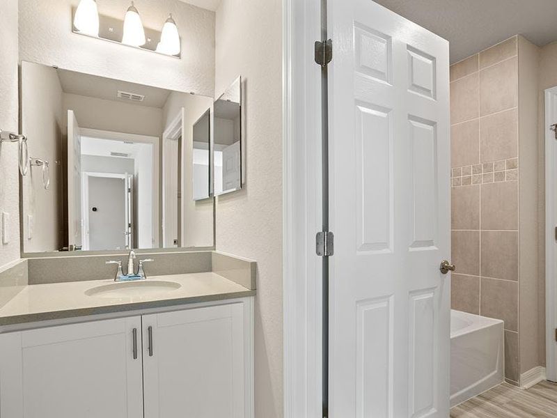 The Jack-and-Jill bath has individual vanities for each bedroom - Capri bungalow by Highland Homes