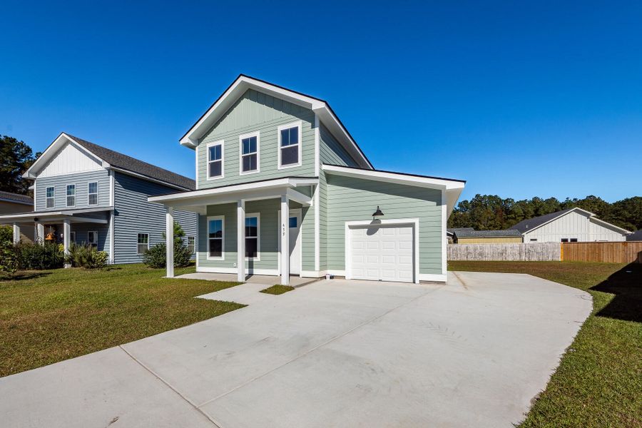 Front exterior of a new home in , Huger, SC, highlighting curb appeal (Image 1).
