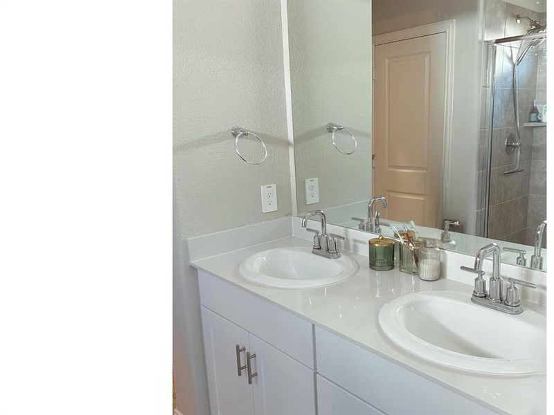 Bathroom featuring vanity and an enclosed shower