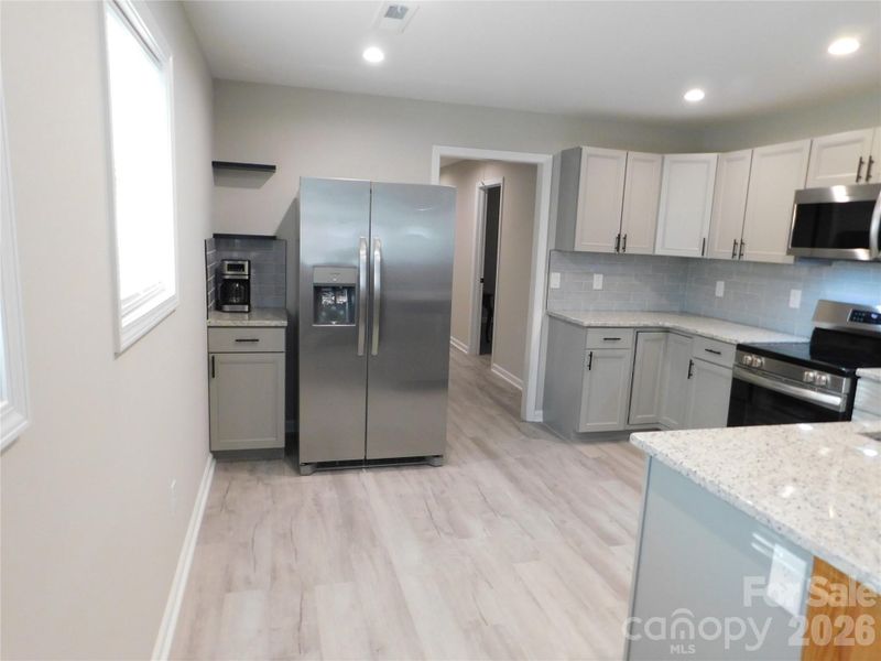 Coffee bar beside refrigerator