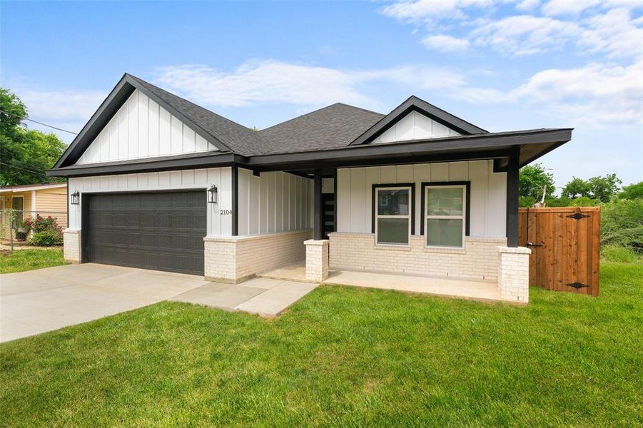 View of front of house featuring brick siding, board and batten siding, an attached garage, and roof with shingles View of front of house featuring brick siding, board and batten siding, an attached garage, and roof with shingles