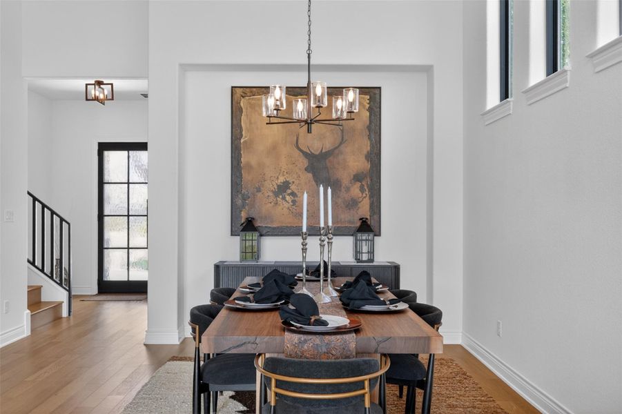 Hardwood floors and crisp white walls create a clean, elegant foundation for gatherings in this inviting dining space. Hardwood floors and crisp white walls create a clean, elegant foundation for gatherings in this inviting dining space.