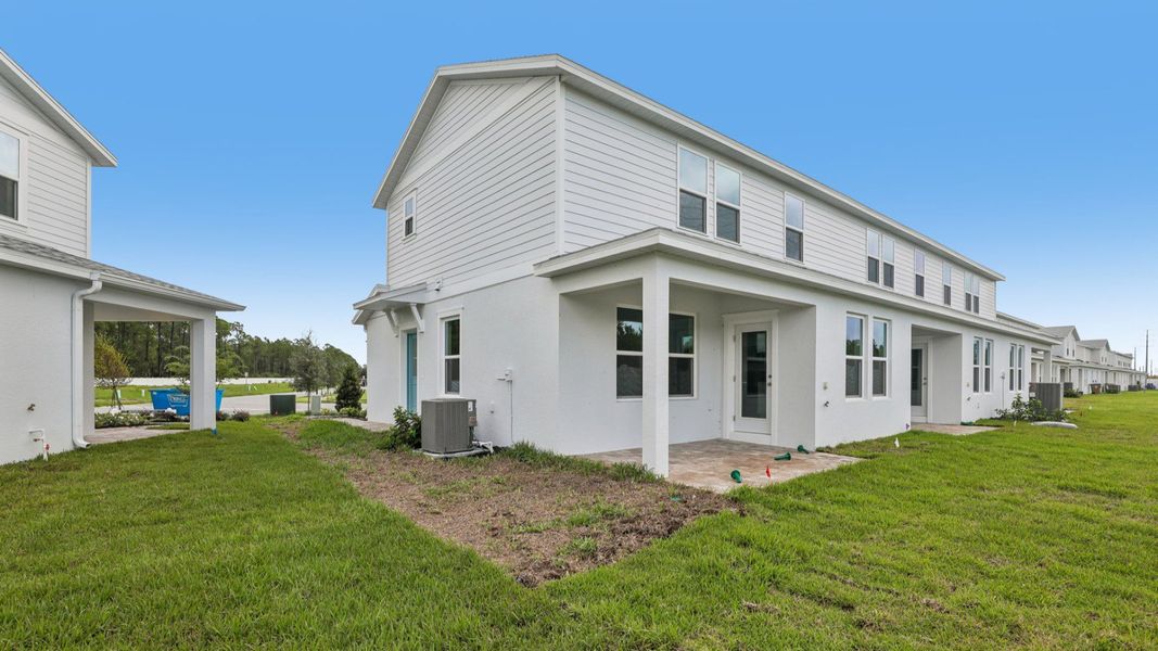Exterior details and patio area of a home in Cyrene at Harmony, St. Cloud (Image 24).
