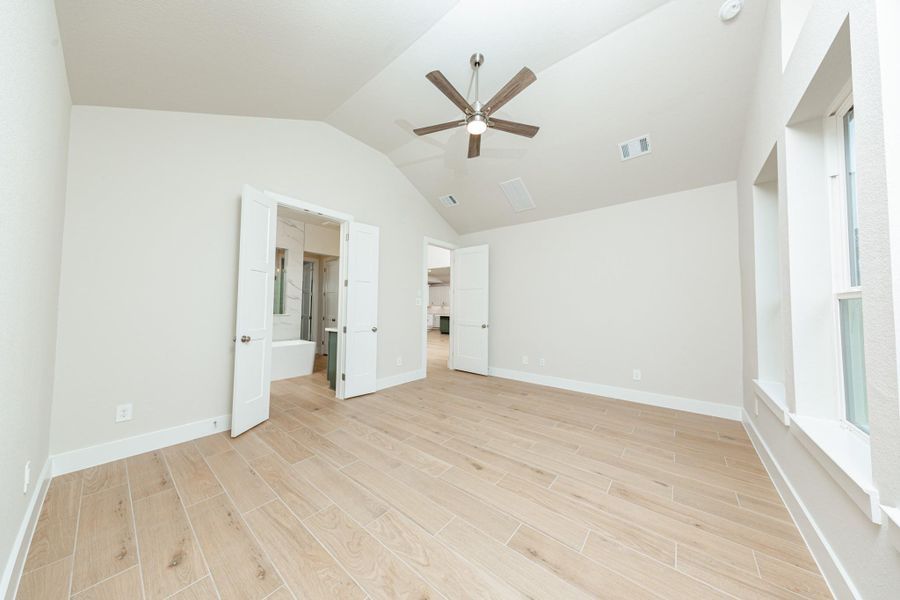 Additional view from primary bedroom looking towards the double door entrance to primary bathroom.