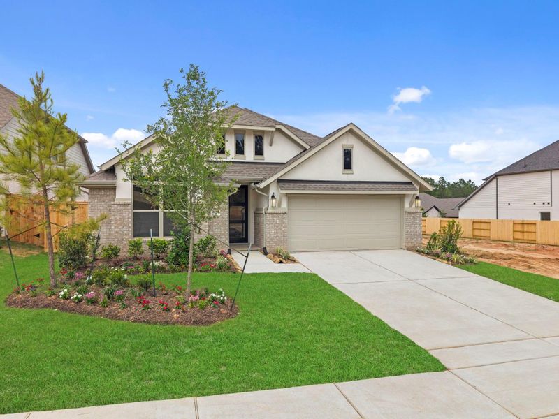 Front exterior of a new home in Wildtree, Magnolia, TX, highlighting curb appeal (Image 21).