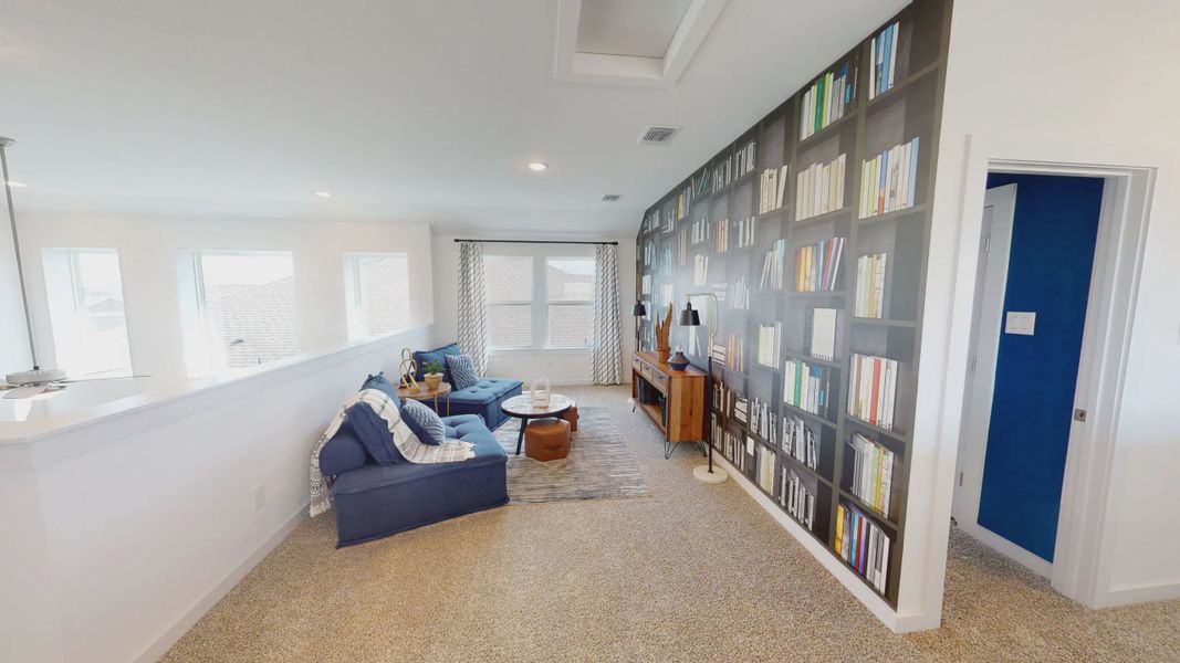Representative furnished interior of a home built from the Saxony by Chesmar Homes in Sunterra, Katy (Image 9).