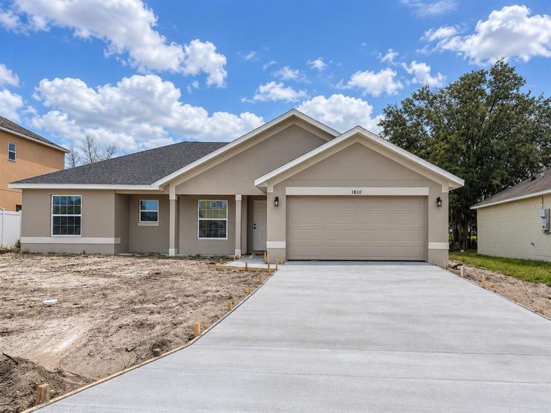 Front exterior of a new home in Poinciana - Polk County, Poinciana, FL, highlighting curb appeal (Image 1). Front exterior of a new home in Poinciana - Polk County, Poinciana, FL, highlighting curb appeal (Image 1).
