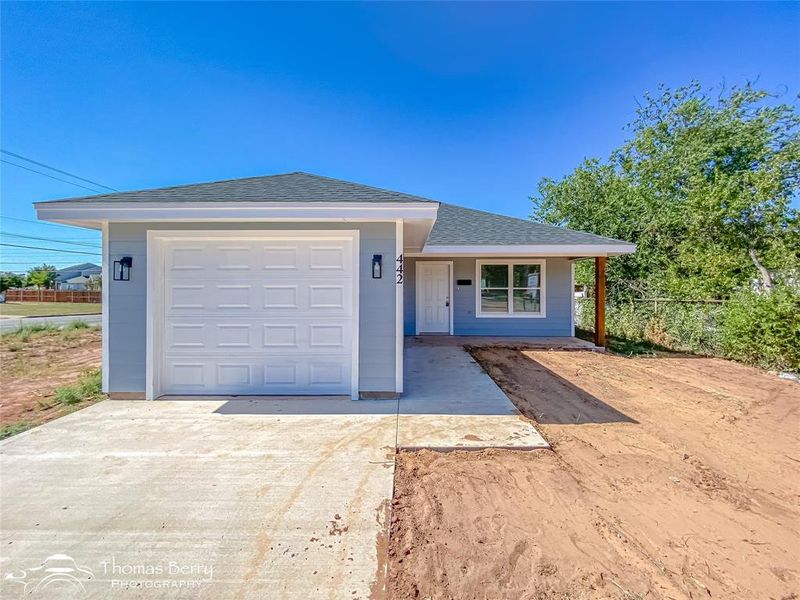 Ranch-style house with driveway, roof with shingles, a garage, and covered porch Ranch-style house with driveway, roof with shingles, a garage, and covered porch