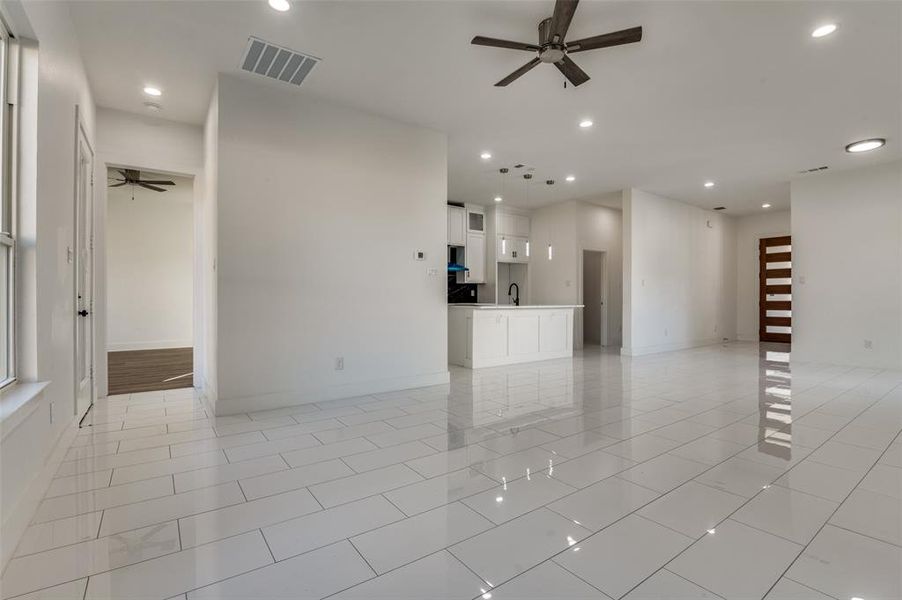 Unfurnished living room with ceiling fan, recessed lighting, and light tile patterned floors