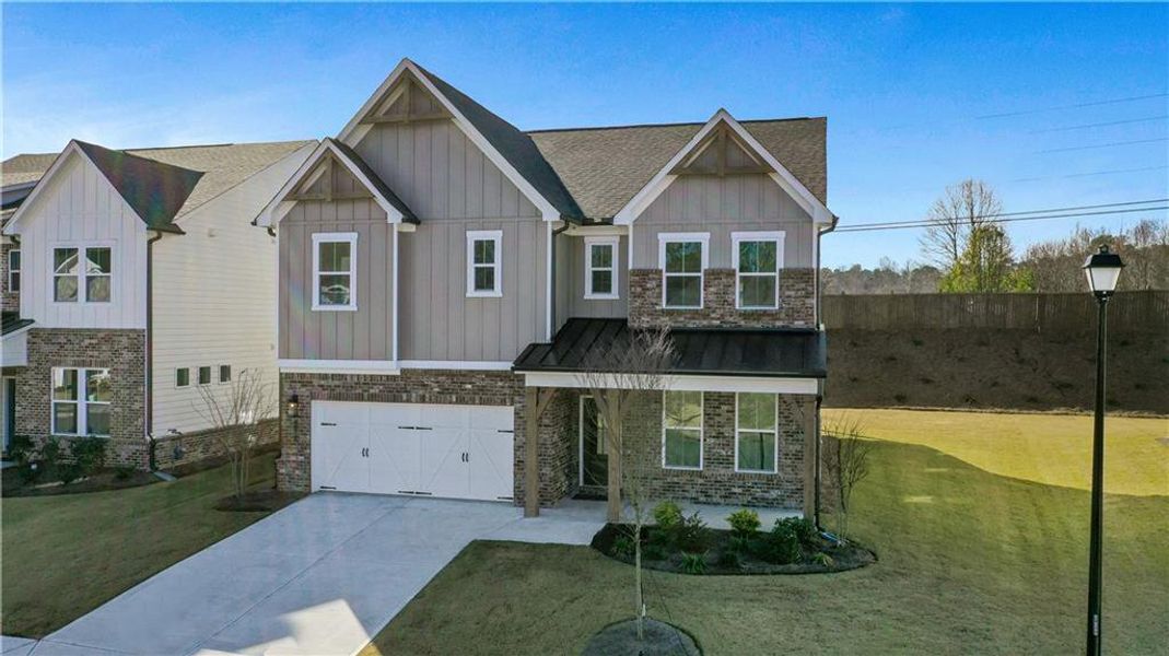 Front exterior of a new home in The Paddocks at Doc Hughes, Buford, GA, highlighting curb appeal (Image 1). Front exterior of a new home in The Paddocks at Doc Hughes, Buford, GA, highlighting curb appeal (Image 1).