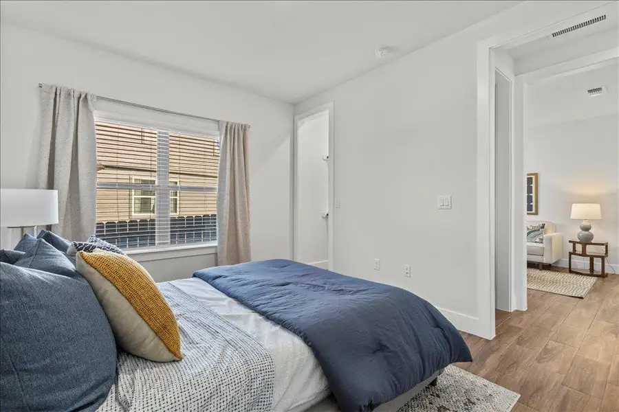 Bedroom featuring wood finished floors and baseboards