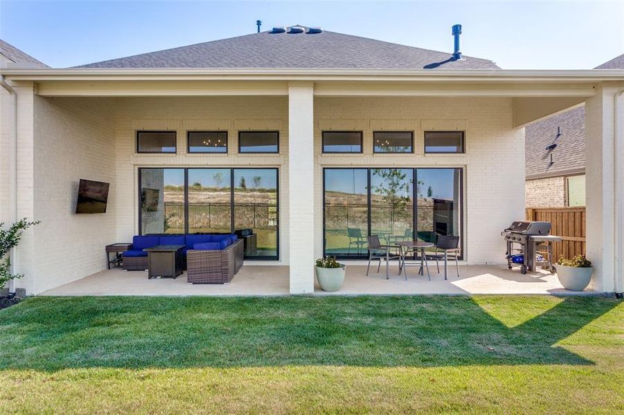 Back of house with a patio, a yard, and a shingled roof Back of house with a patio, a yard, and a shingled roof