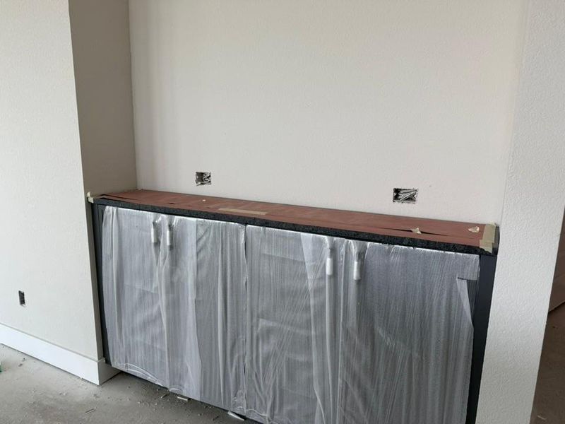 Detailed view of unfinished concrete floors and baseboards