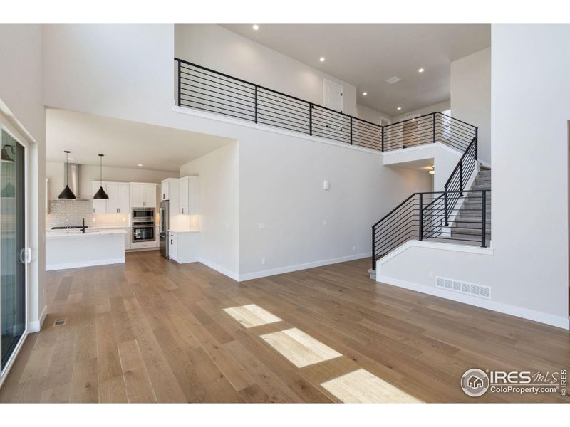 Wide plank flooring and modern staircase