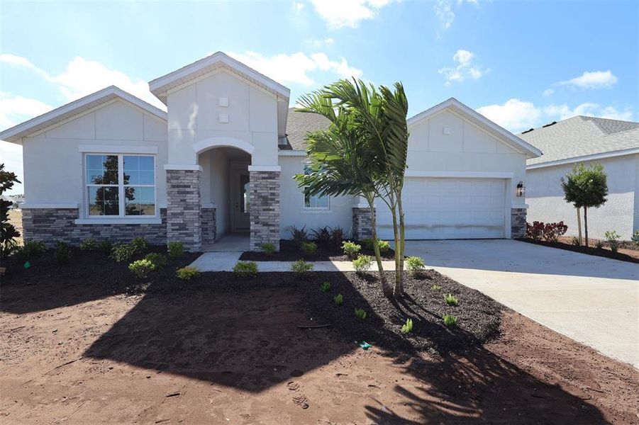 Front exterior of a new home in Coasterra, Palmetto, FL, highlighting curb appeal (Image 1).