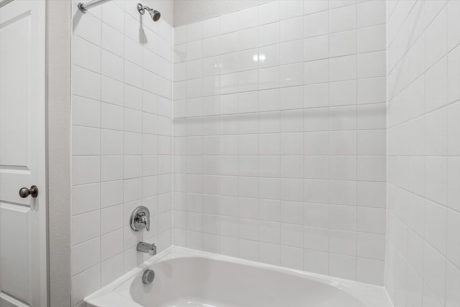 A white tiled bathroom.