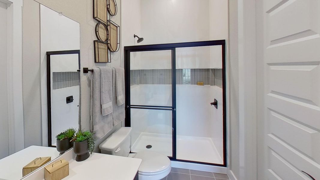 Bathroom with a stall shower, vanity, and tile patterned floors