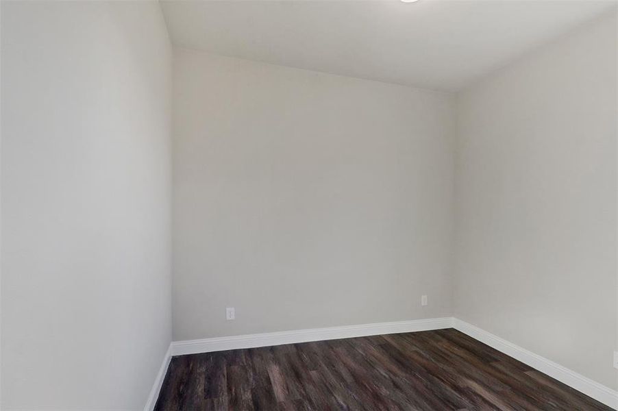 Unfurnished room featuring dark wood-type flooring