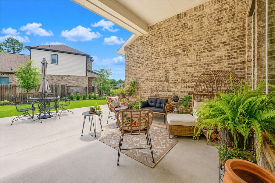 Covered seating area overlooking the backyard. Covered seating area overlooking the backyard.