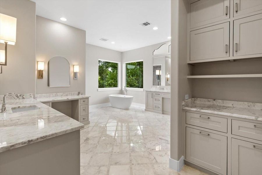 Large primary bath - features a coffee bar, dual hampers, custom designed dual vanities, make up area