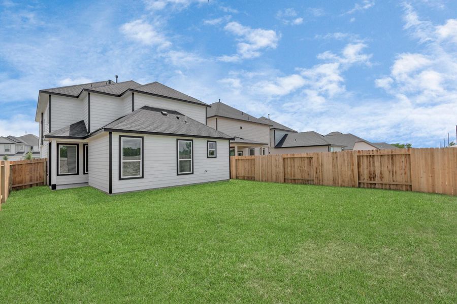 Step into a world of outdoor possibilities with this remarkable backyard and its charming covered patio. From playtime for the kids to relaxation for the adults, this space offers the best of both worlds. Customize it with patio furniture, a BBQ pit, and more, turning it into the ultimate outdoor retreat that suits your lifestyle. Sample photo of completed home with similar floor plan. Actual colors and selections may vary.