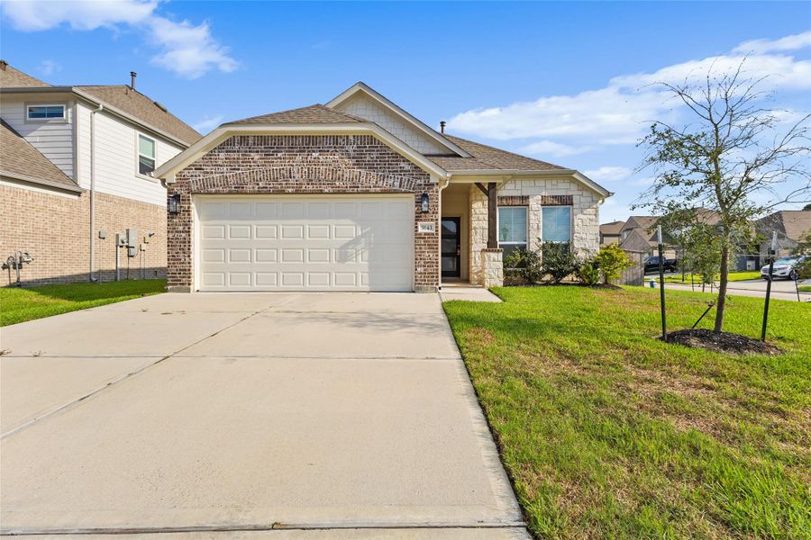 This charming one story home showcases a classic mix of brick and stone, with a covered front porch and gable roofline adding architectural character. Manicured landscaping, a young shade tree, and a wide driveway complete the picture under clear blue skies. It's a home that makes a lasting first impression from the moment you pull up. This charming one story home showcases a classic mix of brick and stone, with a covered front porch and gable roofline adding architectural character. Manicured landscaping, a young shade tree, and a wide driveway complete the picture under clear blue skies. It's a home that makes a lasting first impression from the moment you pull up.