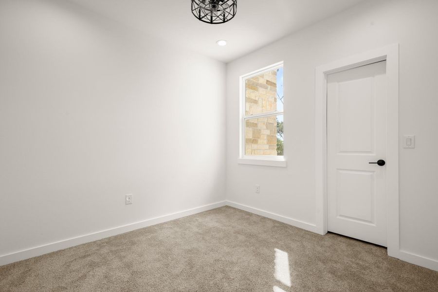 Carpeted spare room with baseboards