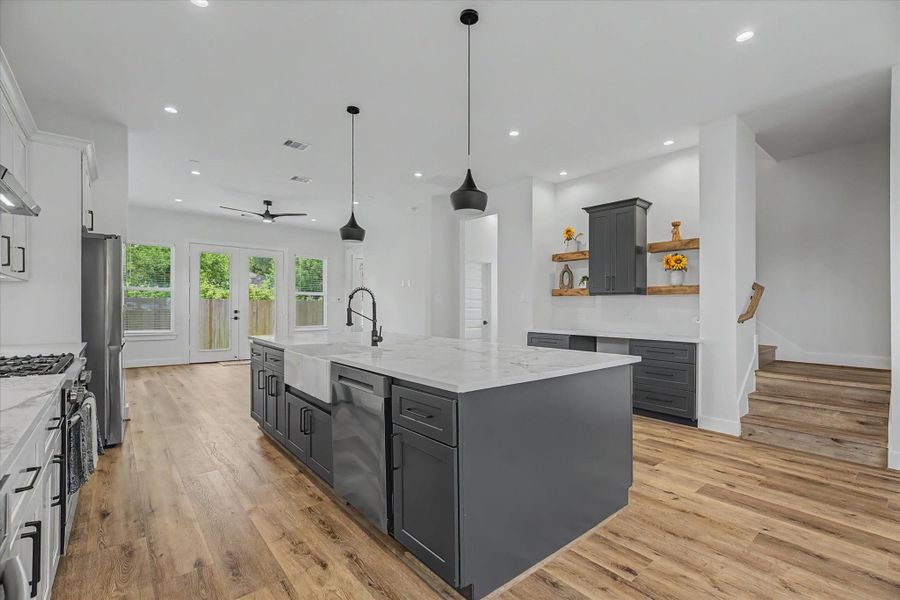 Modern kitchen featuring an apron-front sink, complemented by a high-efficiency Samsung 5.0 Cu. Ft. Smart Front Load Washer with Steam. This Wi-Fi-enabled appl
