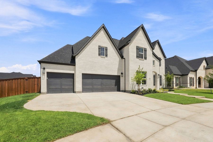 Front exterior of a new home in Estates at Rockhill, Frisco, TX, highlighting curb appeal (Image 26). Front exterior of a new home in Estates at Rockhill, Frisco, TX, highlighting curb appeal (Image 26).