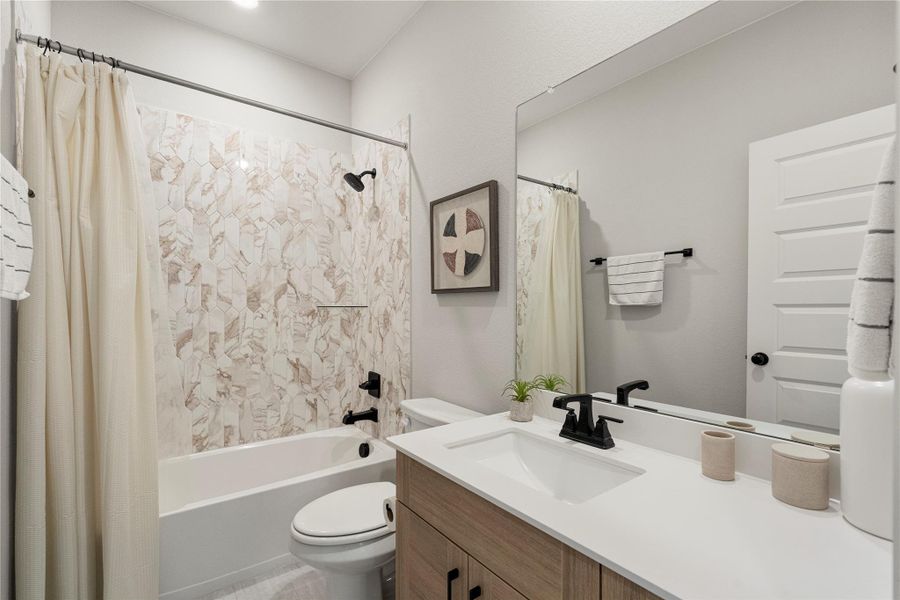 A well-appointed bathroom featuring a contemporary vanity and elegant tile work in the shower. A well-appointed bathroom featuring a contemporary vanity and elegant tile work in the shower.