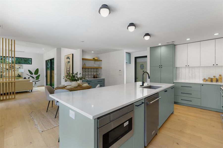 Designer lighting and 7.5” Wire Brushed Lisbon White Oak Wood flooring throughout the home creates a warm and inviting ambiance.