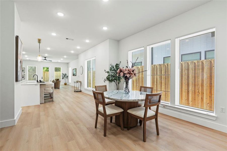 Dining space featuring recessed lighting, light wood-type flooring, and a ceiling fan Dining space featuring recessed lighting, light wood-type flooring, and a ceiling fan